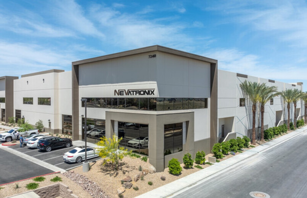 Exterior of the Nevatronix headquarters building in Las Vegas with rooftop signage and palm trees