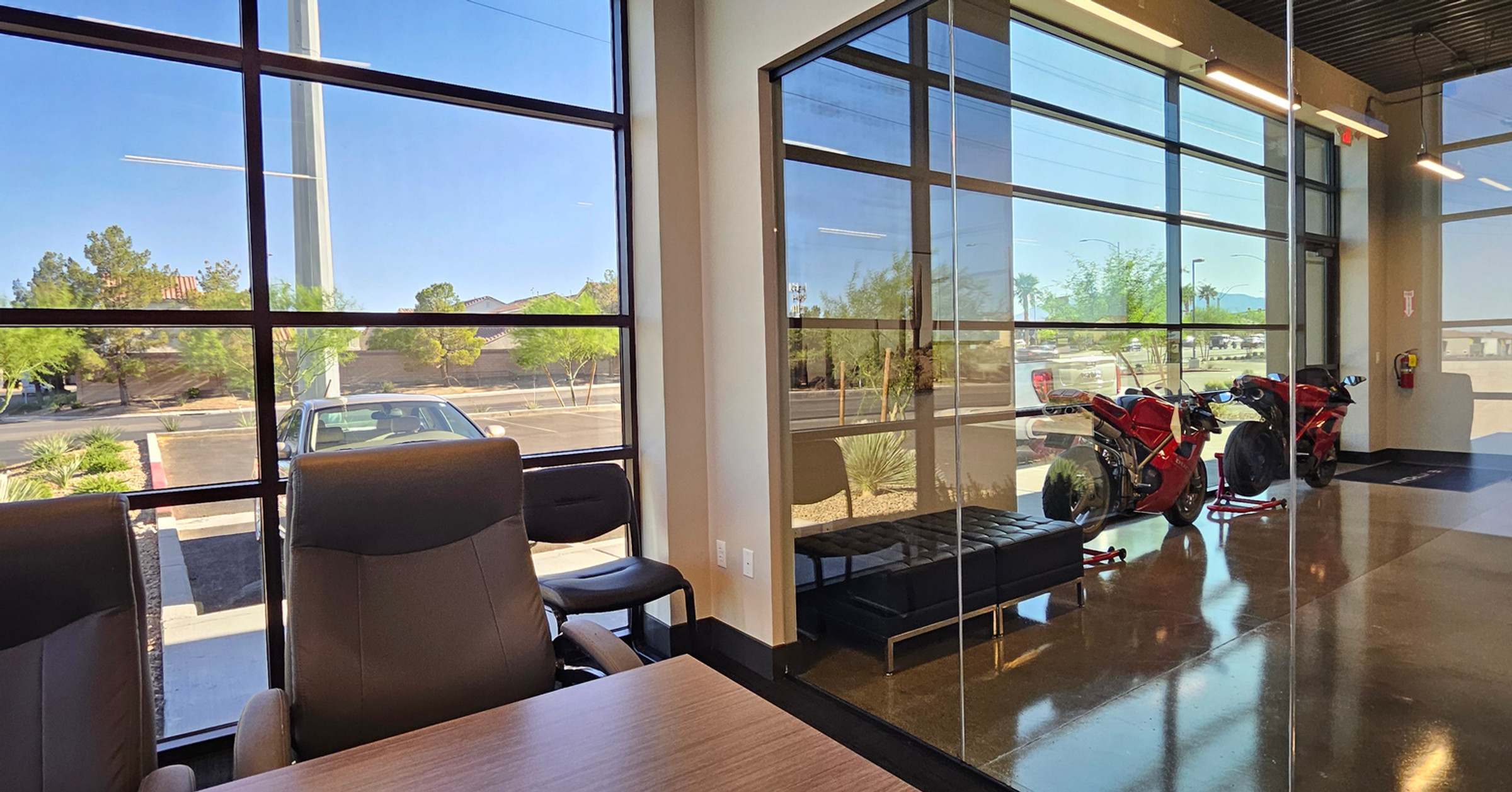 Interior of the Nevatronix office lobby with floor-to-ceiling windows overlooking the Las Vegas parking lot